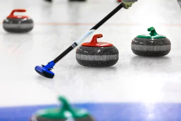 Fototapeten curling game - stones and broom on the ice © ronstik