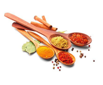 Spice. Various spices in wooden spoons over white background. Curry, saffron, turmeric, cinnamon