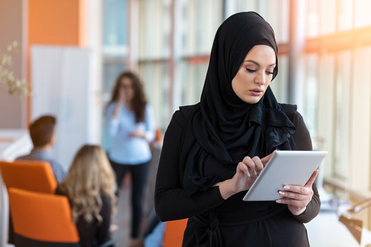 Pretty woman wearing hijab in front of laptop search and doing office work, business, finance and workstation concept.