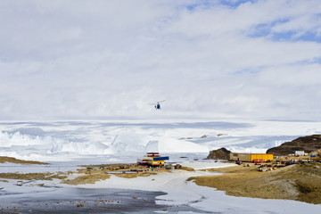 Helicopter with cargo on suspension, over the station in Antarctica © Sergey