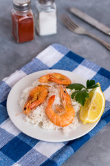 Plate with fried prawns and rice. Seafood.