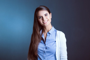 Portrait of a businesswoman , against dark background. Woman smiling. Portrait of a woman