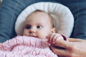 Baby hand holding mother's hands