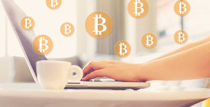 Bitcoin with woman using a laptop in brightly lit room