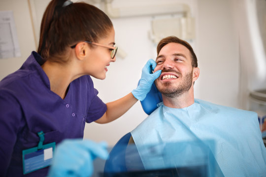 Dentist looking patient’s teeth