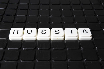 Russia text word title caption label cover backdrop background. Alphabet letter toy blocks on black...