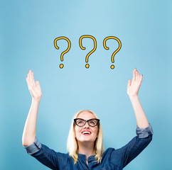 Question Marks with young woman reaching and looking upwards
