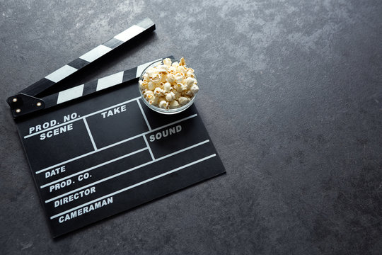 Cinema concept with movie theatre elements set of clapper board and popcorn.