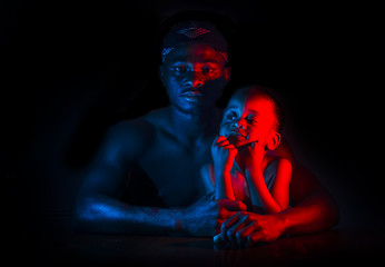 African man and child red blue silhouette.