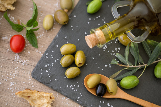 top view green and black healthy olive on the wooden table.