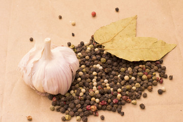 Fugural still life photo image of pile of spices, garlic, craft paper and pepper balls