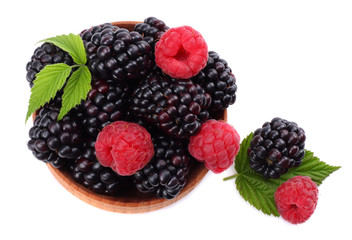 blackberries with raspberries in wooden bowl isolated on white background top view