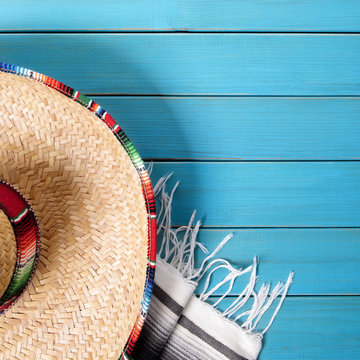 Cinco de mayo mexican background border with mexico sombrero straw hat blanket rug on old blue wood fiesta festival photo square format