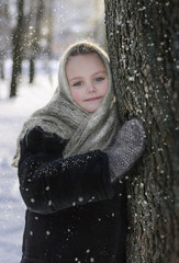 Beautiful little girl in shawl in winter