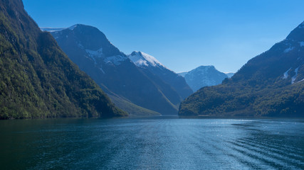 Naklejka na ściany i meble Beautiful norwegian Fjord with blue clear sky from Gudvangen to Flam, Norway