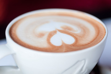 Close-up on a coffee cup with heart shape