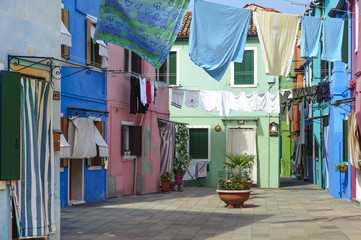 glimpse of the island of Burano in Venice with its characteristic colored houses and hanging clothes