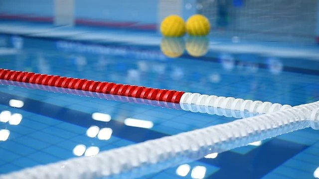 Olympic swimming pool lane dividers during water polo match
