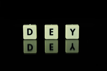 blocks with letters set on a glass table. Words arranged from letters on a glass substrate. The...