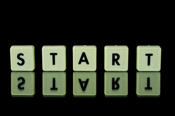 blocks with letters set on a glass table. Words arranged from letters on a glass substrate. The...
