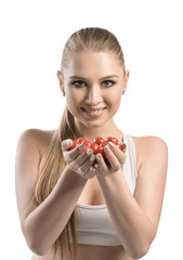 View of a beautiful young woman holding tomatoes