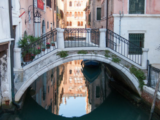 Fototapeta na wymiar Beautiful bridge over little Venetian canal