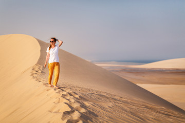 Fototapeta na wymiar Young woman enjoying desert