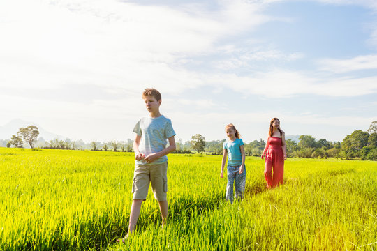 Family walking in rice field