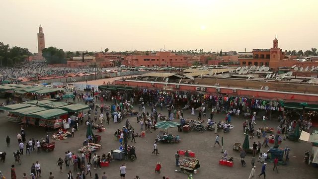 Crowds of pedestrians walking in old town Medina in Marrakesh, Morocco. Crowd of people on city square Africa.