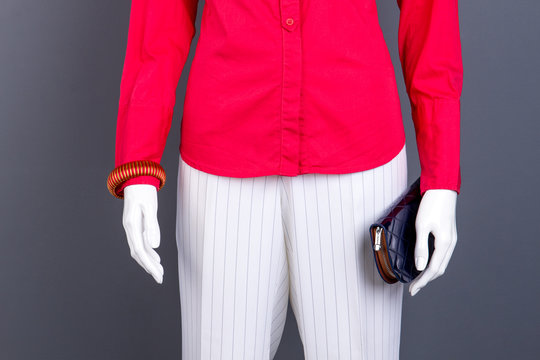 Red blouse, bracelet and wallet. Female red shirt and white striped trousers. Women classic outfit.