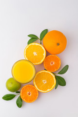 Glass of fresh citrus fruit Juice with green leaf isolated on white background. Flat lay