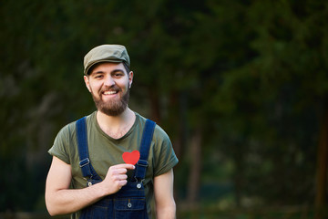 Handsome smiling bearded man holding hearts