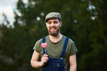 Handsome smiling bearded man holding hearts