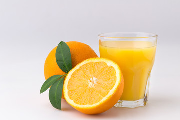 Glass of fresh citrus fruit Juice with green leaf isolated on white background