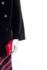 Mannequin with coat and wallet, cropped image. Female skirt, purse and overcoat close up, copy space. Feminine fashion and style.