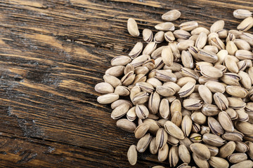 tasty pistachios lying on the table,  space for text