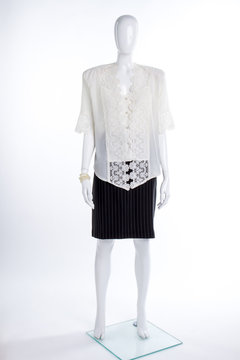 White lace blouse and black skirt. Full length female mannequin dressed in elegant silk blouse and black skirt. Ladies classy apparel.