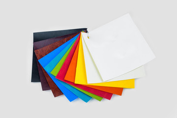 colored samples of fabric on the background. place for text. top view