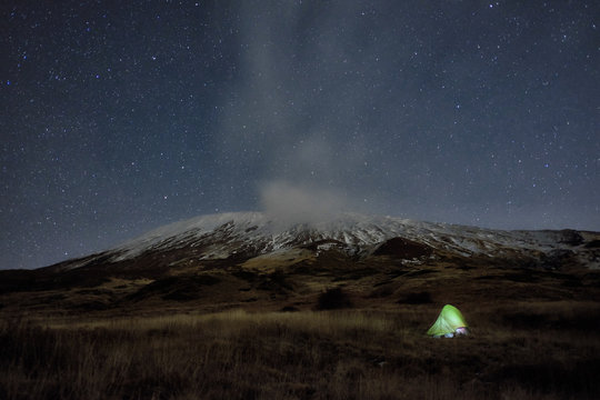 Lighting Tent Under Winter Etna Mount And Starry Night, Sicily
