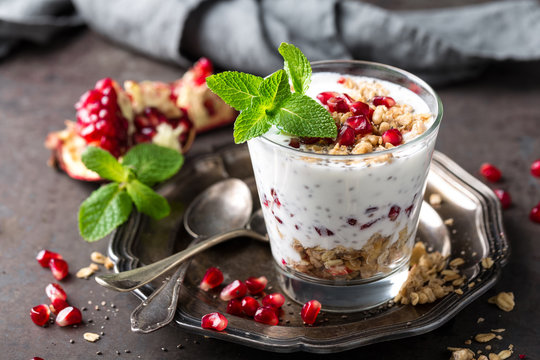 Chia pudding parfait with pomegranate, granola and light greek yogurt. Healthy eating