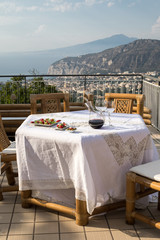 Prepared for supper table on the terrace overlooking the Bay of Naples and  Vesuvius. Sorrento. Italy