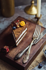A piece of chocolate cake on wooden background. Happy birthday background