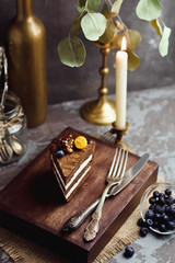 A piece of chocolate cake on wooden background. Happy birthday background