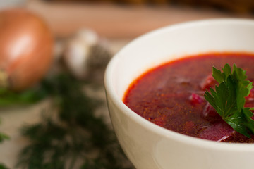 Borsch - beetroot soup in a clay bowl on a slate,stone or metal background,traditional dish of ukrainian cuisine.Top view.