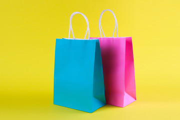 multicolored Shopping bags on yellow background, sale, purchase