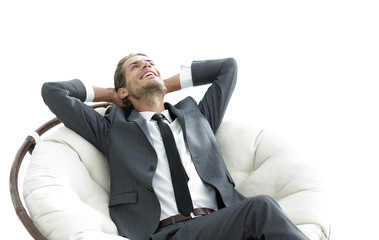 young businessman meditating in big comfortable armchair
