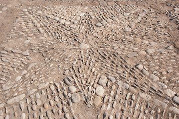 Part of stone road in Spain Fort. Background old texture walkway.Ornament star.