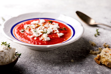 Tomato soup  and fresh tomatoes cherry  on a wooden background Gazpacho