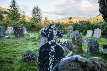 Old grey tombstone on historic graveyard in Ireland