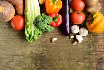 Organic vegetables assorted wooden background, top view, banner.